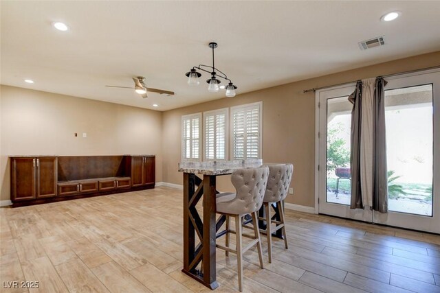 5301 Fairbranch Ln, Las Vegas, NV 89135 - dining area featuring ceiling fan, visible vents, baseboards, and light wood-type flooring