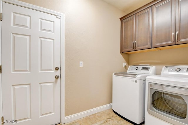 5301 Fairbranch Ln, Las Vegas, NV 89135 - laundry area featuring baseboards, cabinet space, independent washer and dryer, and light wood finished floors