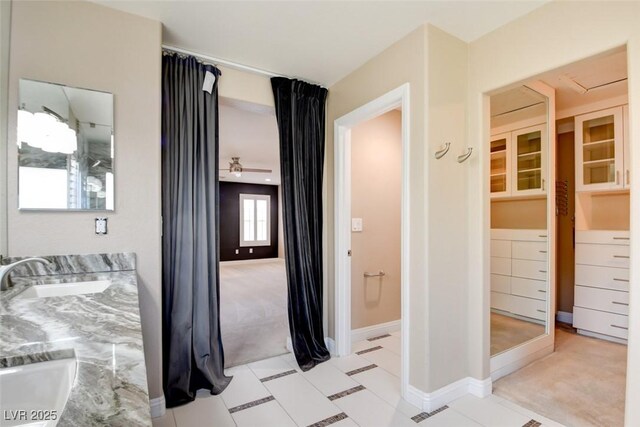 5301 Fairbranch Ln, Las Vegas, NV 89135 - bedroom with light colored carpet, a sink, and baseboards