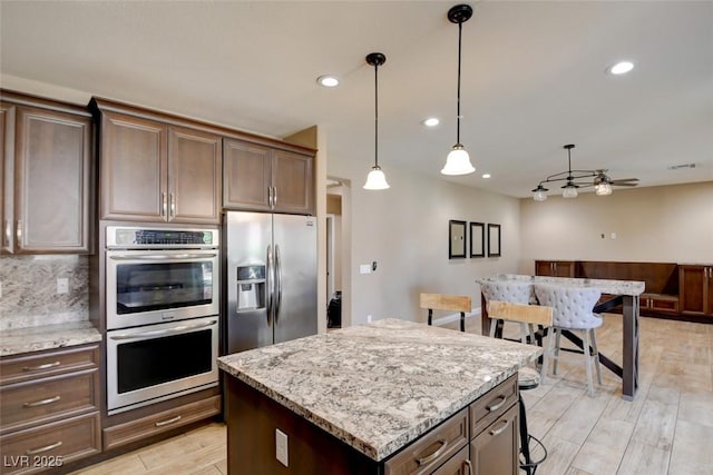 5301 Fairbranch Ln, Las Vegas, NV 89135 - kitchen with a ceiling fan, stainless steel appliances, recessed lighting, and light wood-style flooring