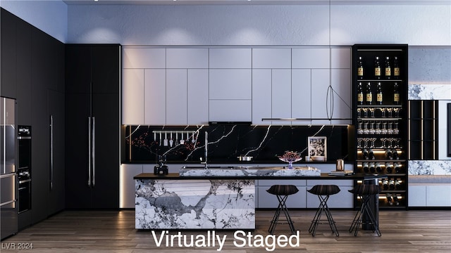 interior space featuring a breakfast bar area, a kitchen island, and dark wood-type flooring