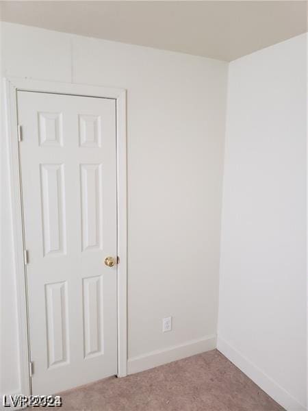 spare room featuring baseboards and carpet floors