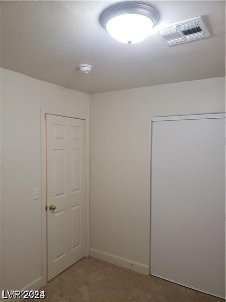 unfurnished room featuring visible vents and baseboards