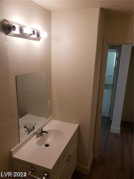 bathroom featuring hardwood / wood-style flooring and vanity