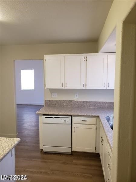 kitchen with white cabinetry, dark hardwood / wood-style floors, and white dishwasher