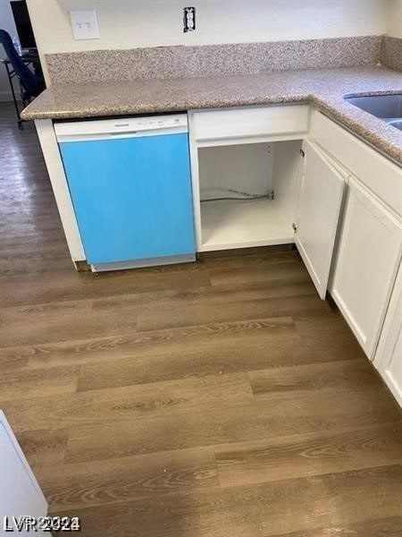 details with dark hardwood / wood-style flooring, white dishwasher, and white cabinetry