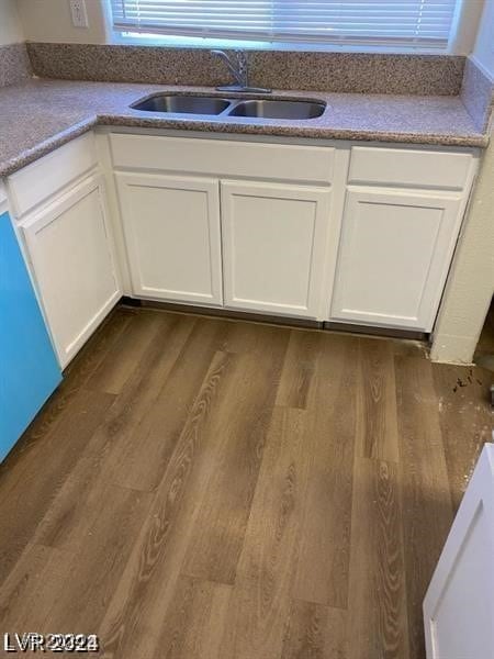 room details featuring sink, white cabinetry, and dark hardwood / wood-style floors