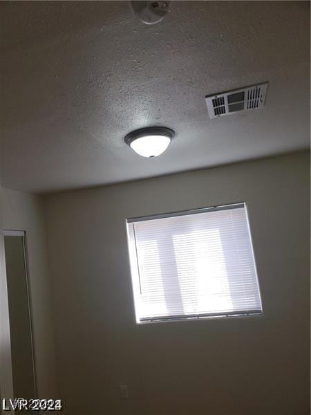 interior details with visible vents and a textured ceiling