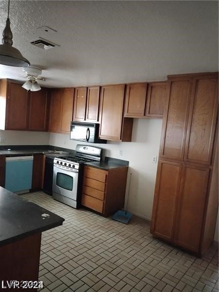 kitchen with ceiling fan, pendant lighting, range with gas stovetop, and dishwashing machine