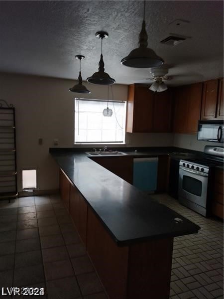 kitchen with ceiling fan, white gas stove, pendant lighting, dishwasher, and kitchen peninsula