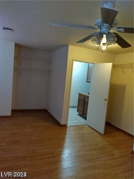 unfurnished bedroom featuring a closet, ceiling fan, and hardwood / wood-style floors