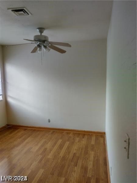 spare room featuring hardwood / wood-style flooring and ceiling fan