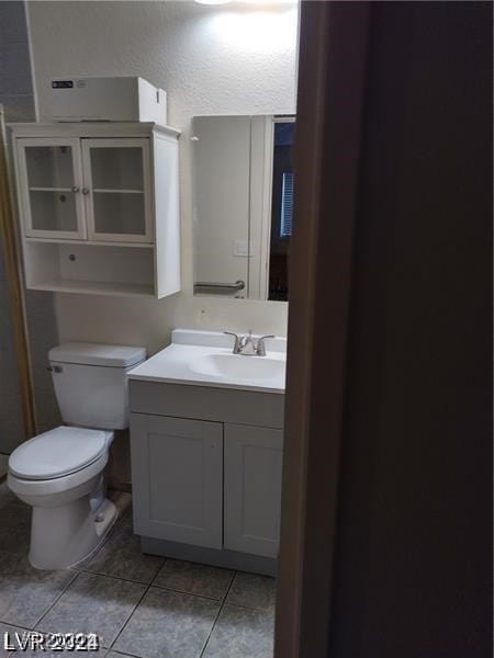 bathroom with tile patterned floors, toilet, and vanity