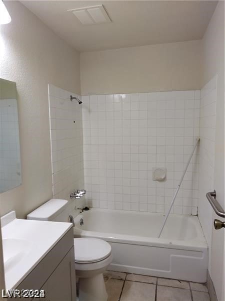 full bathroom with vanity, tiled shower / bath combo, and toilet