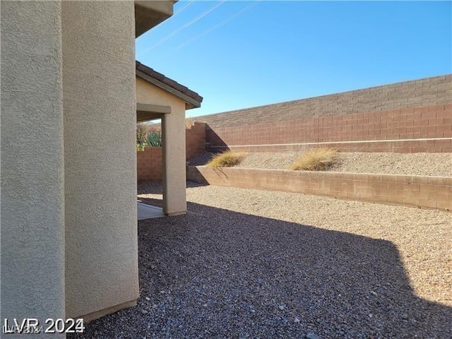 view of yard featuring a patio area and a fenced backyard