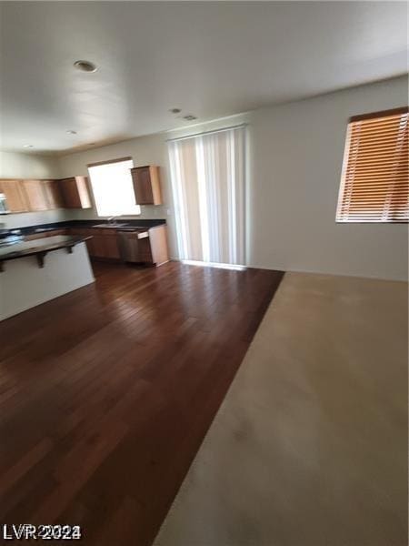 kitchen featuring dark wood-type flooring and dark countertops