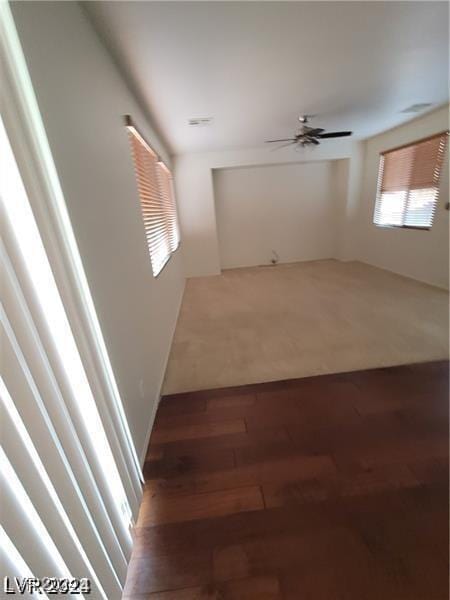 unfurnished room featuring wood finished floors and a ceiling fan