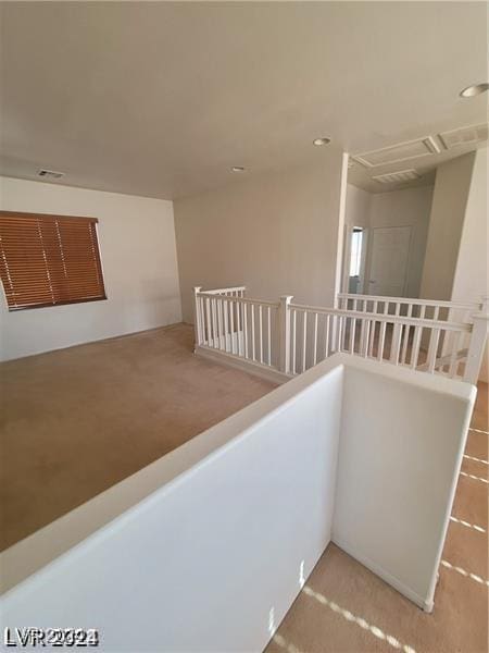 hallway featuring an upstairs landing