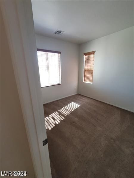 unfurnished room with visible vents and carpet floors