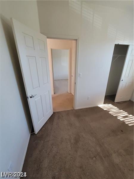 unfurnished bedroom with carpet and a closet