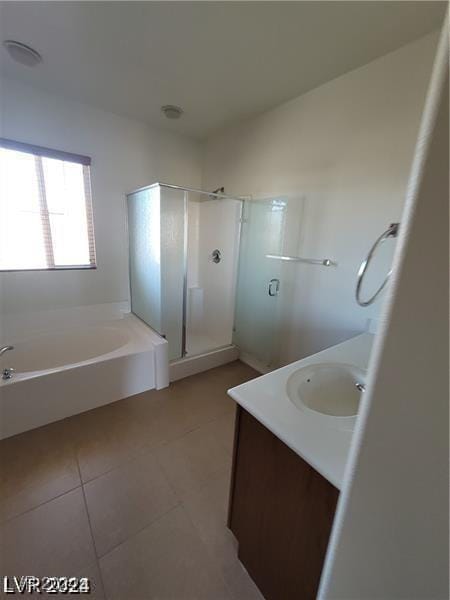 bathroom featuring vanity, a shower stall, a bath, and tile patterned floors