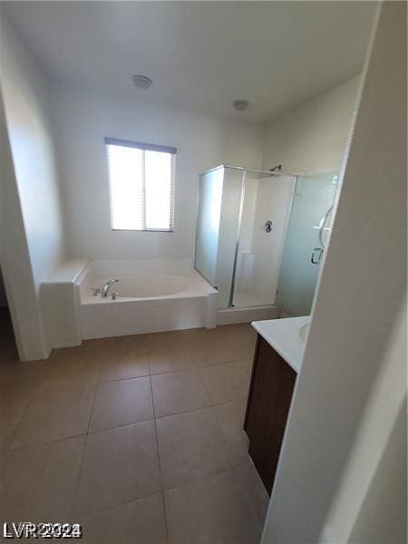 full bath with vanity, tile patterned floors, a garden tub, and a stall shower