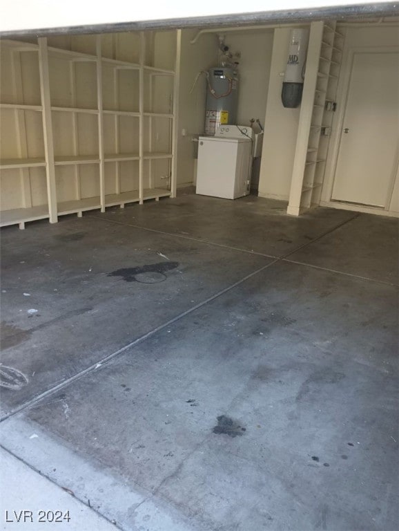 garage featuring washer / clothes dryer and water heater