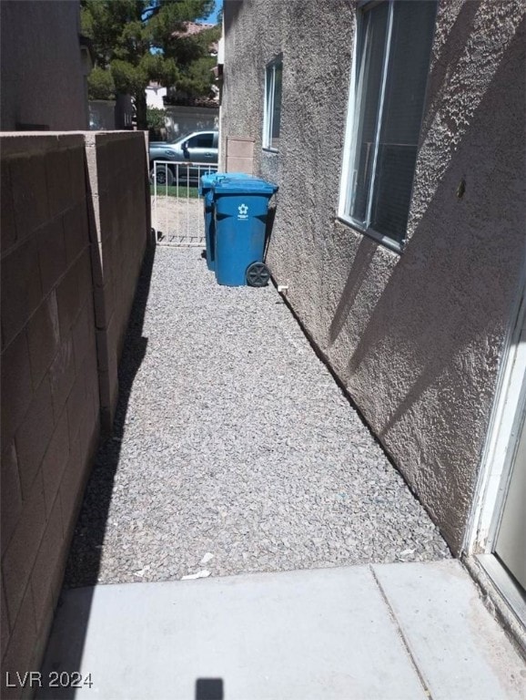 exterior details with stucco siding and fence