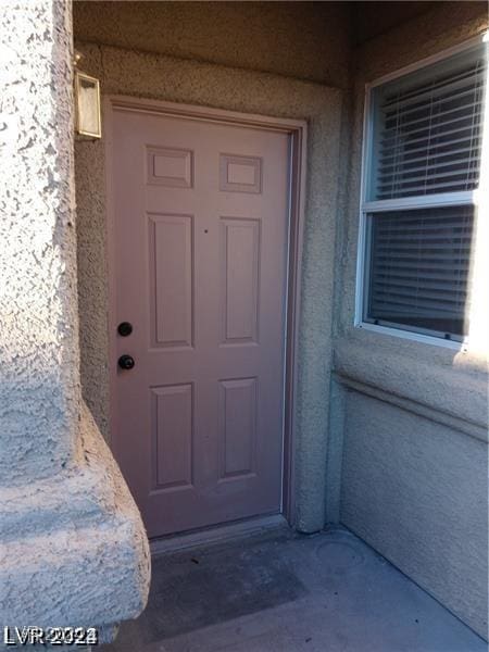 property entrance featuring stucco siding