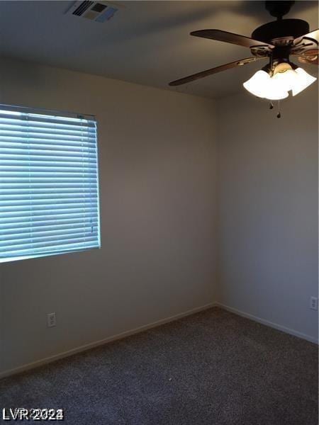 unfurnished room with baseboards, visible vents, carpet floors, and ceiling fan