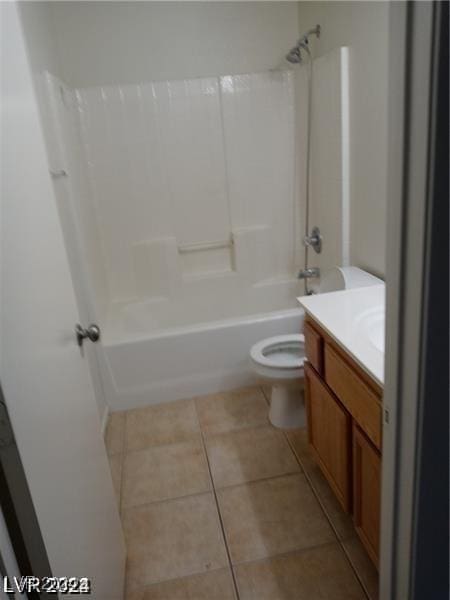 bathroom with tile patterned flooring, toilet, vanity, and shower / bathtub combination