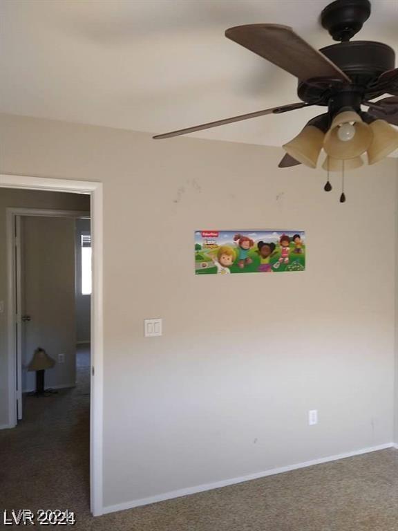 unfurnished room with carpet flooring, baseboards, and ceiling fan