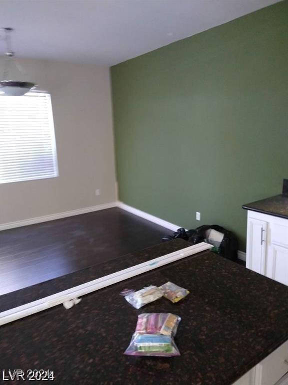 interior space with baseboards and wood finished floors