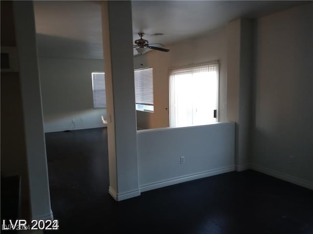 spare room featuring baseboards and ceiling fan