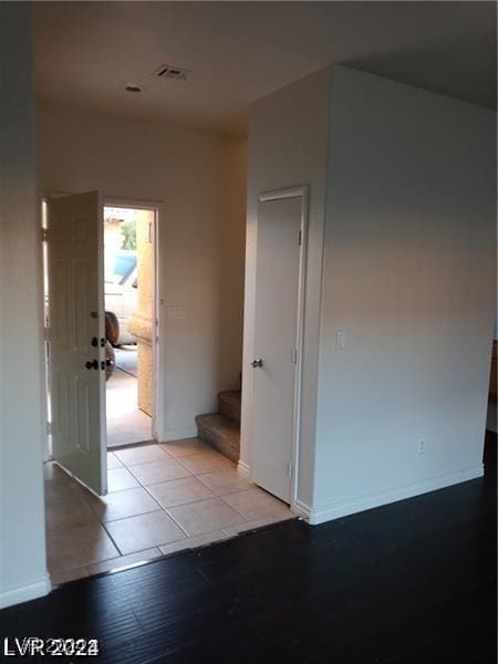 interior space with tile patterned floors, stairway, baseboards, and visible vents