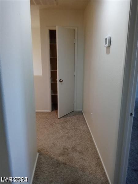 corridor with baseboards and carpet floors