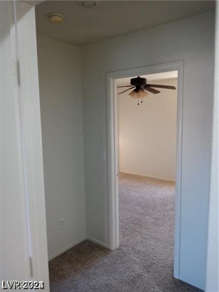 corridor featuring carpet flooring and baseboards