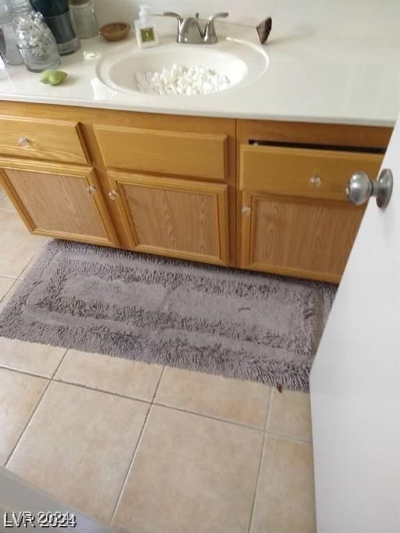 details with vanity and tile patterned floors