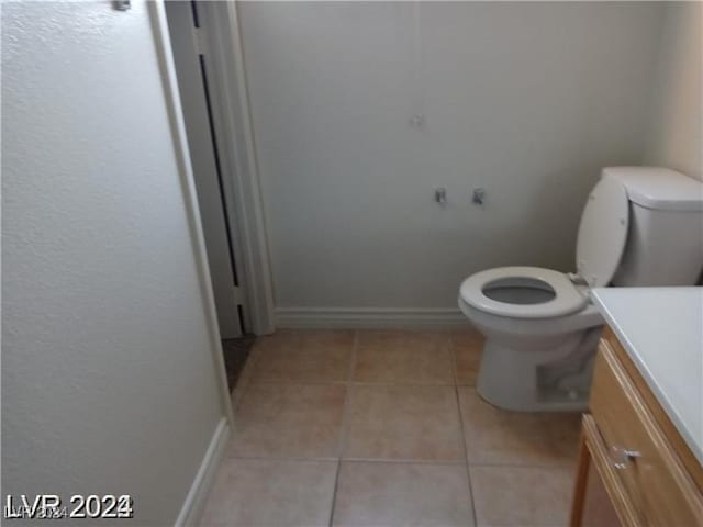 bathroom featuring vanity, tile patterned floors, toilet, and baseboards