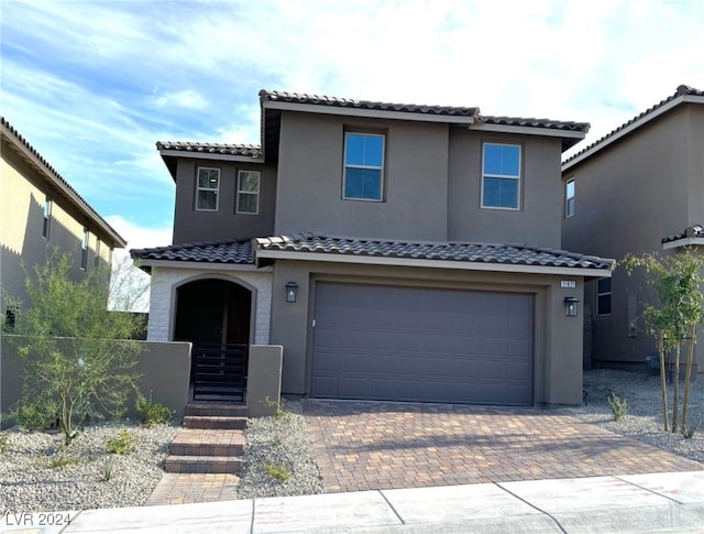 mediterranean / spanish-style home featuring a garage