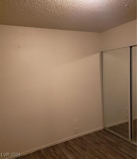 empty room featuring hardwood / wood-style floors and a textured ceiling