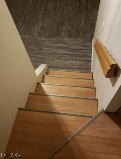 staircase with hardwood / wood-style floors