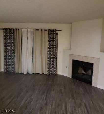 unfurnished living room with dark hardwood / wood-style floors