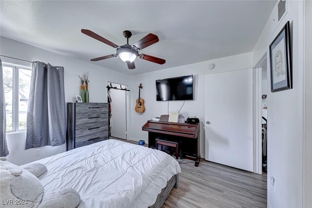 bedroom featuring ceiling fan and light hardwood / wood-style flooring