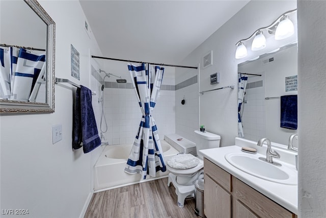 full bathroom featuring hardwood / wood-style flooring, shower / bath combo, vanity, and toilet