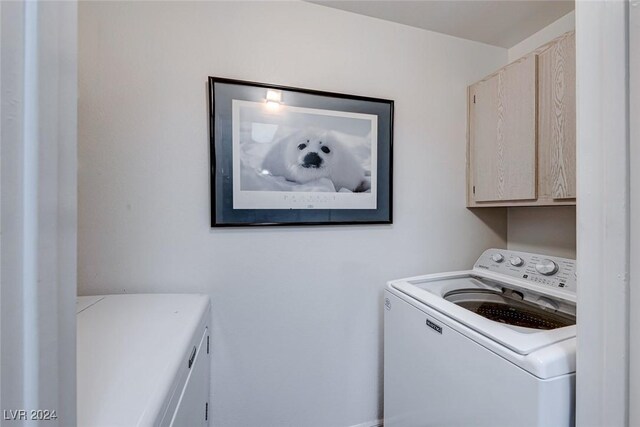 washroom with cabinets and separate washer and dryer