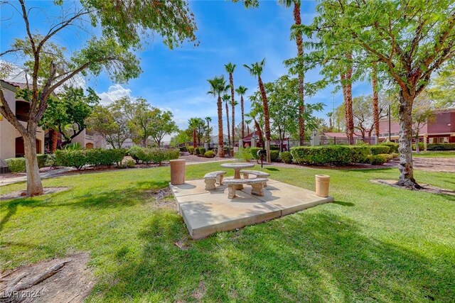 view of home's community featuring a yard and a patio