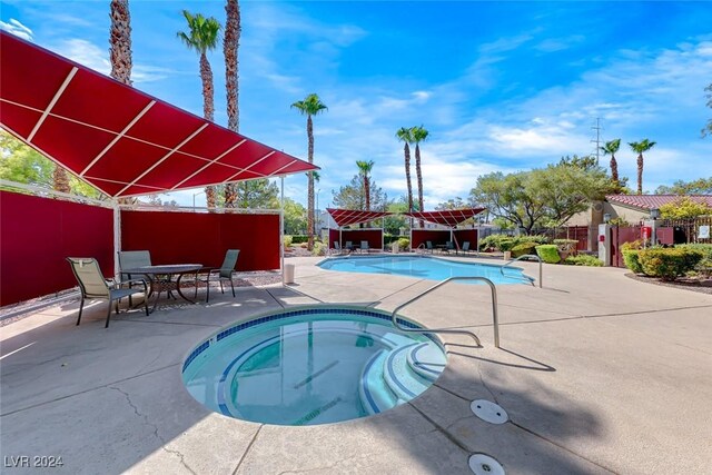 view of pool with a hot tub and a patio area