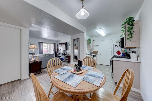 dining space featuring light wood-type flooring