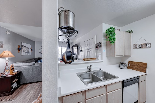 kitchen with sink, white dishwasher, and light wood-type flooring